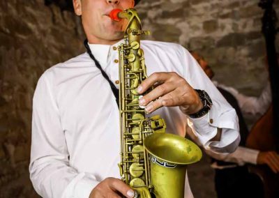 The Deltas saxophone player performing live